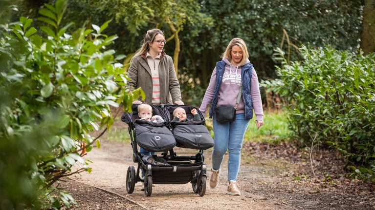 Visitors walking with a double buggy along the multi-use trail at Ickworth Estate, Suffolk